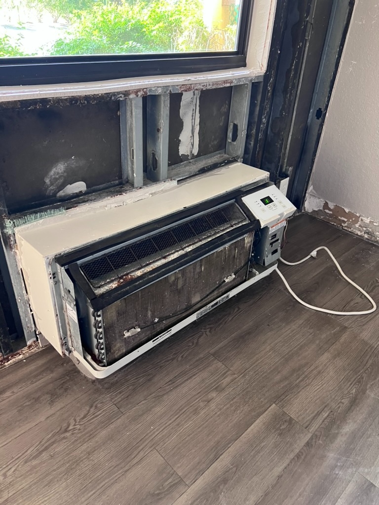 Through-the-wall packaged terminal air conditioner removed from a hotel room wall cavity